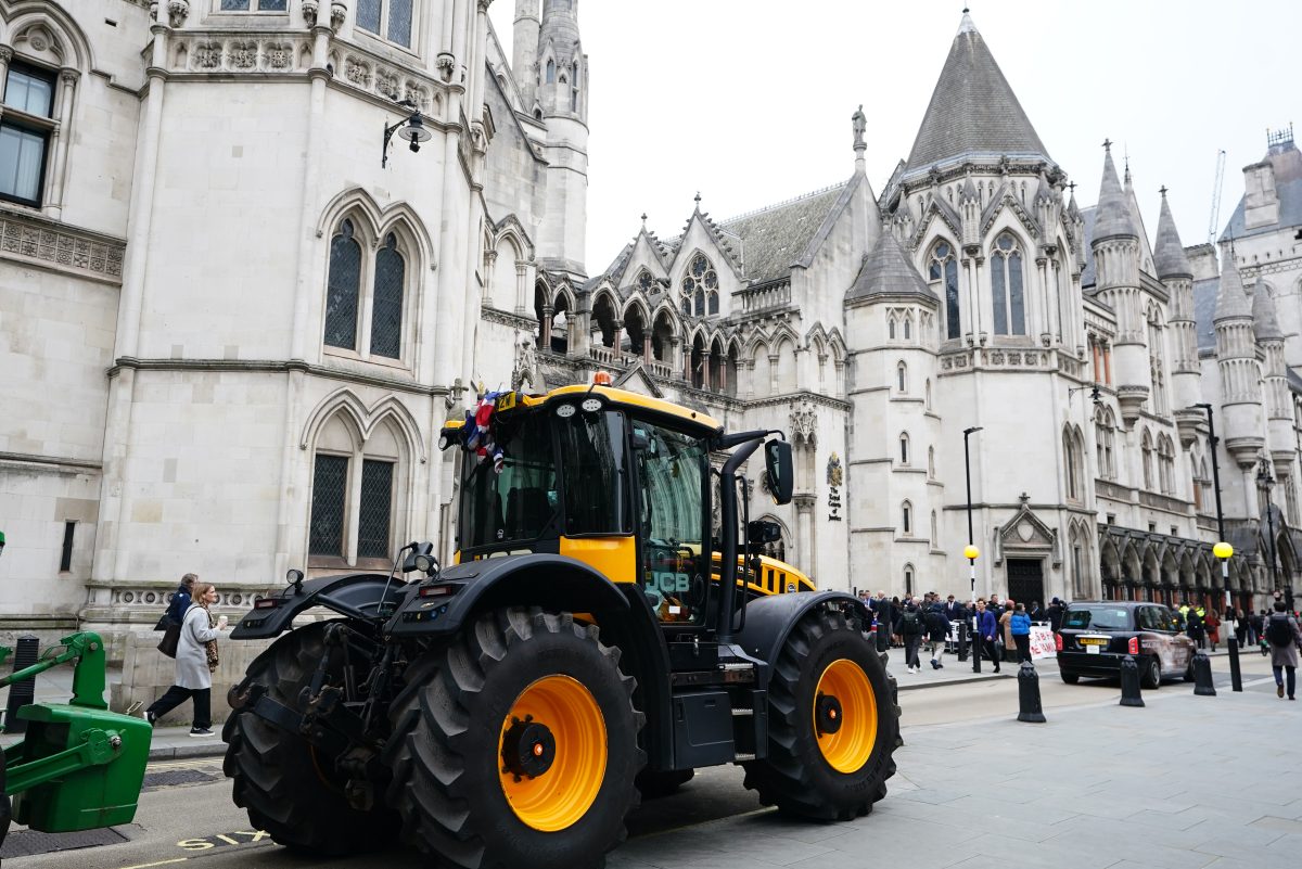 Farmers rally outside high court, holding protest signs and banners, advocating for agricultural rights and policy changes.