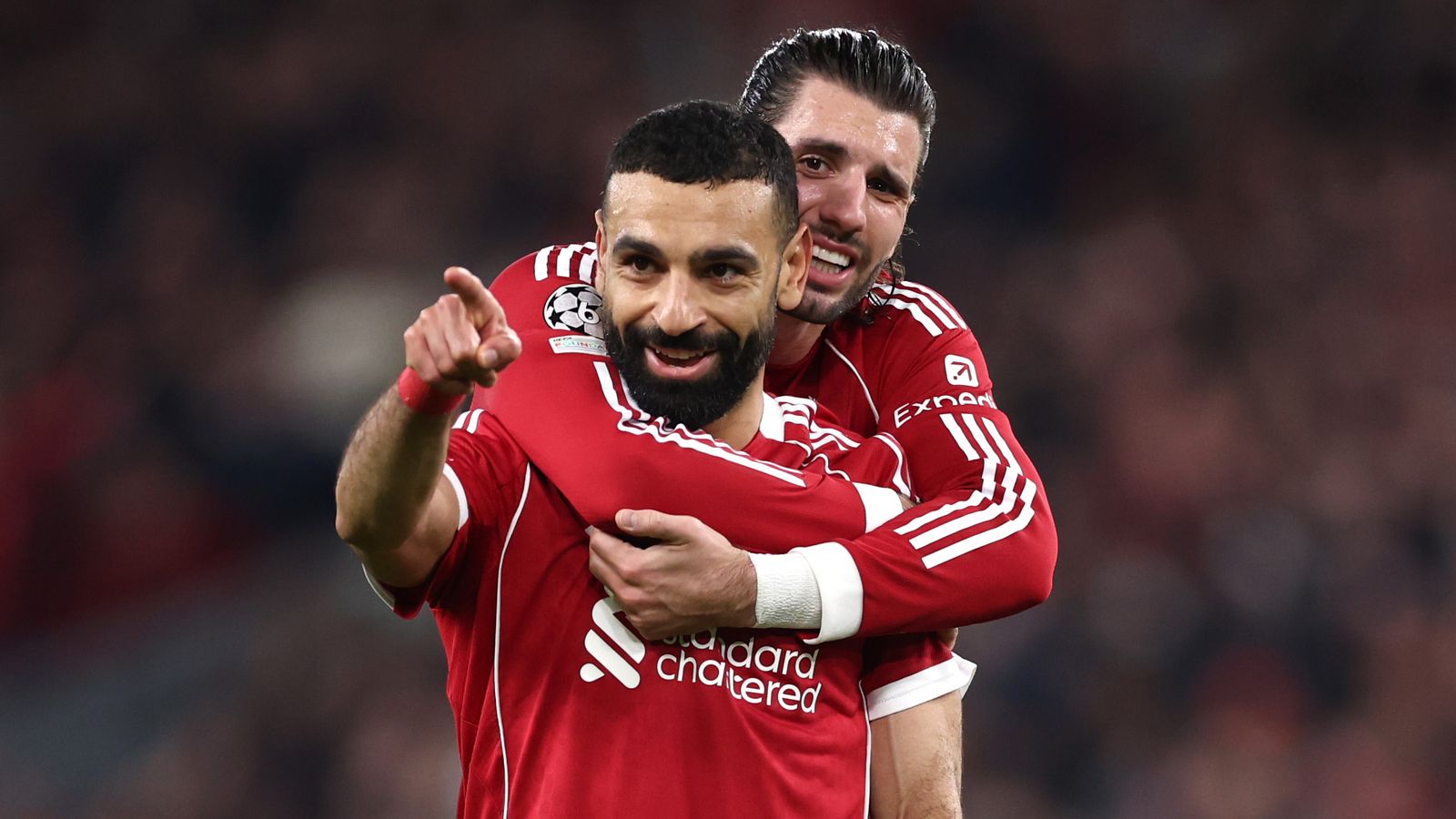 Mohamed Salah is hugged by Dominik Szoboszlai after scoring Liverpool's fourth goal against Galatasaray