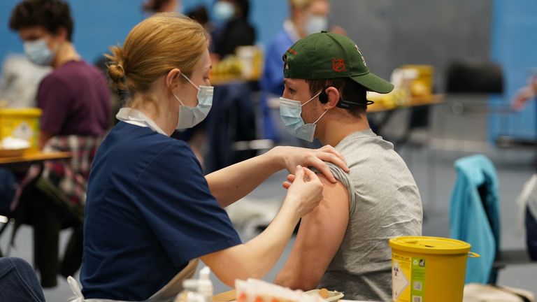 A student receiving an injection in the sports hall at the University of Kent. Pic: PA
