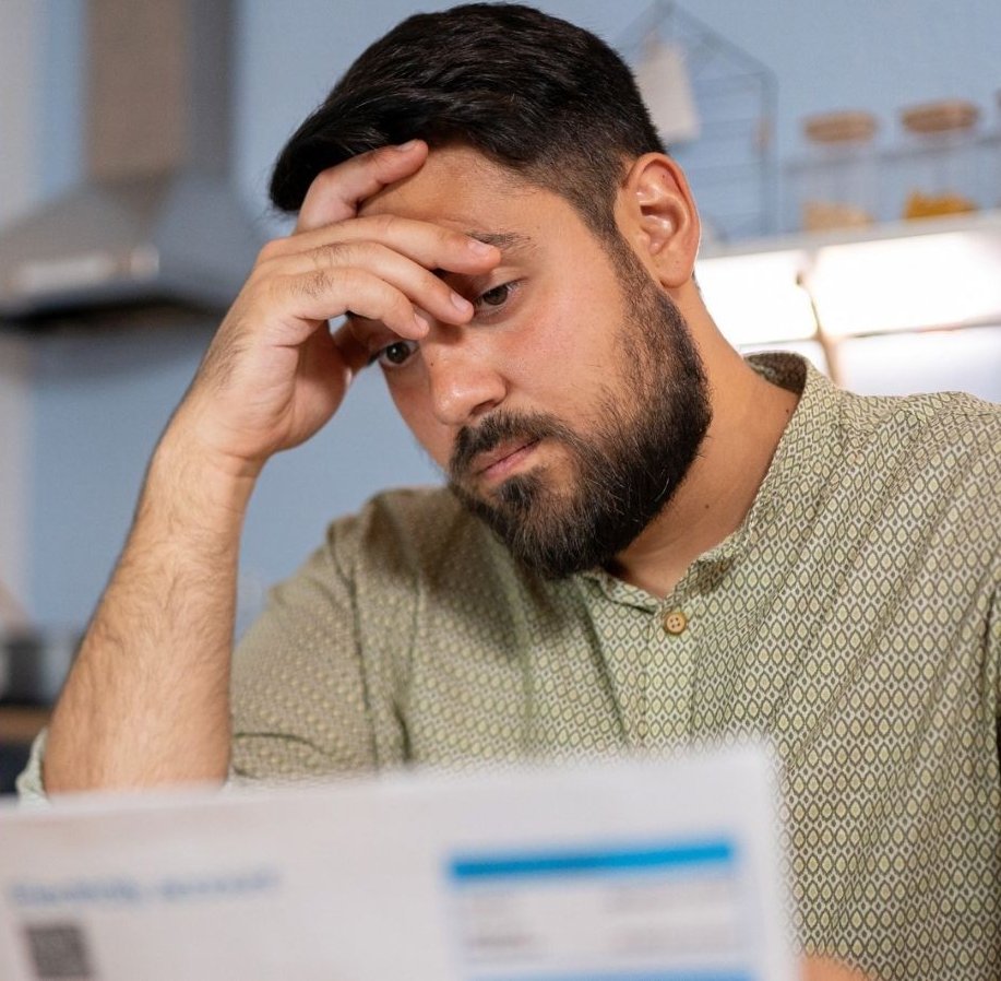 Man looking worried and HMRC letter