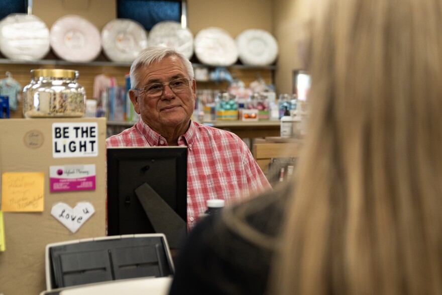 Crystal McEntire, who owns Hyland’s Pharmacy in Wheeler, talks with Danny Hardcastle, a regular customer, about a stock show her son recently attended.
