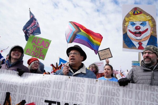 Minnesota Attorney General Keith Ellison, center, and others gather at Saint Paul College during a "No Kings" protest Saturday, March 28, 2026, in St. Paul, Minn. (AP Photo/Joe Scheller)