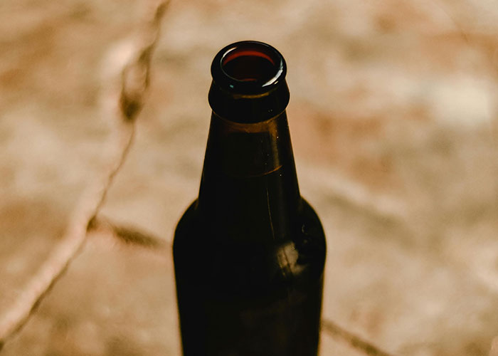 Close-up of an open dark bottle on a textured surface, illustrating one of the medical secrets so dark to fear.