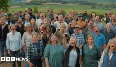 The Hawkstone Choir is a large group of farmers, all together and singing.