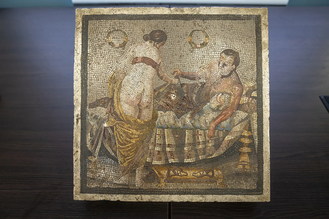 Ancient Roman mosaic depicting a half-naked couple.