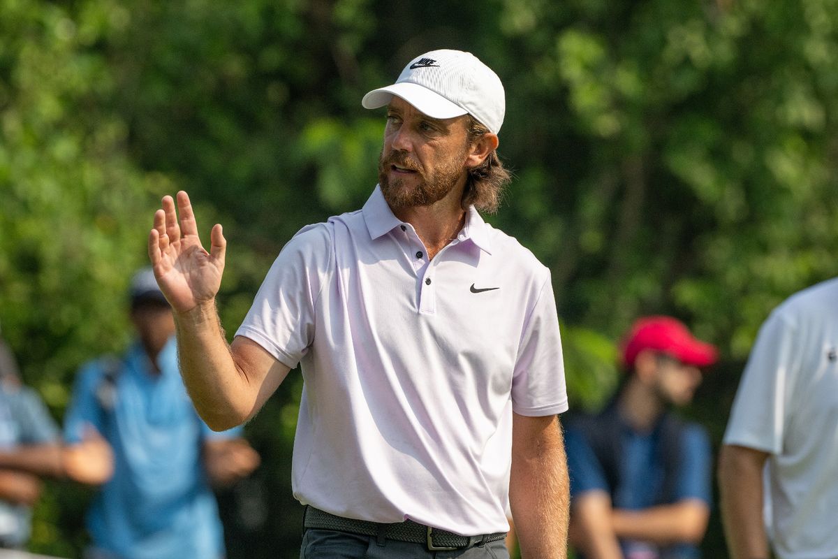 Tommy Fleetwood waving while out on the golf course