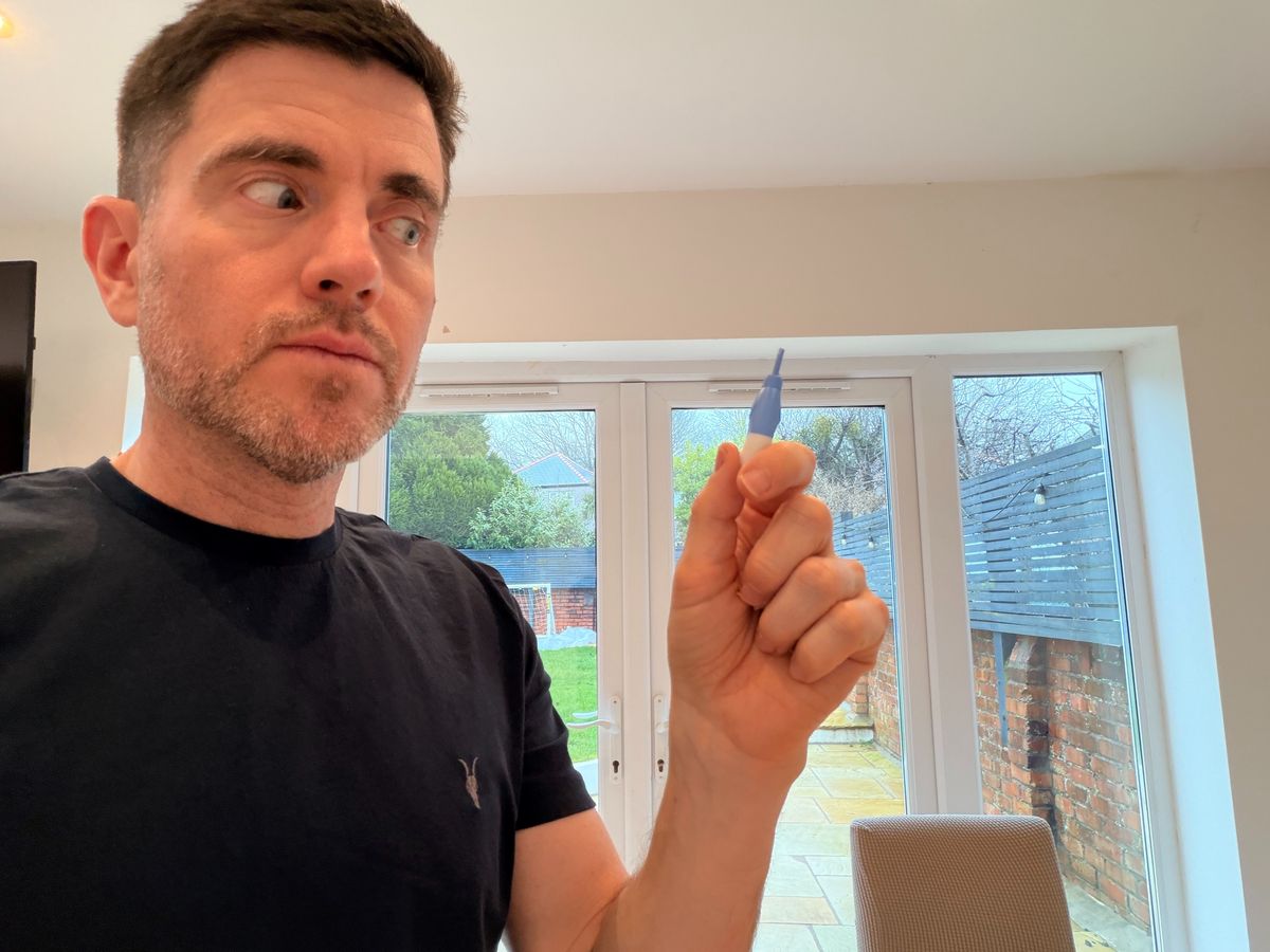 Steffan Rhys looks nervously at a lance he is about to use to take a blood test at home