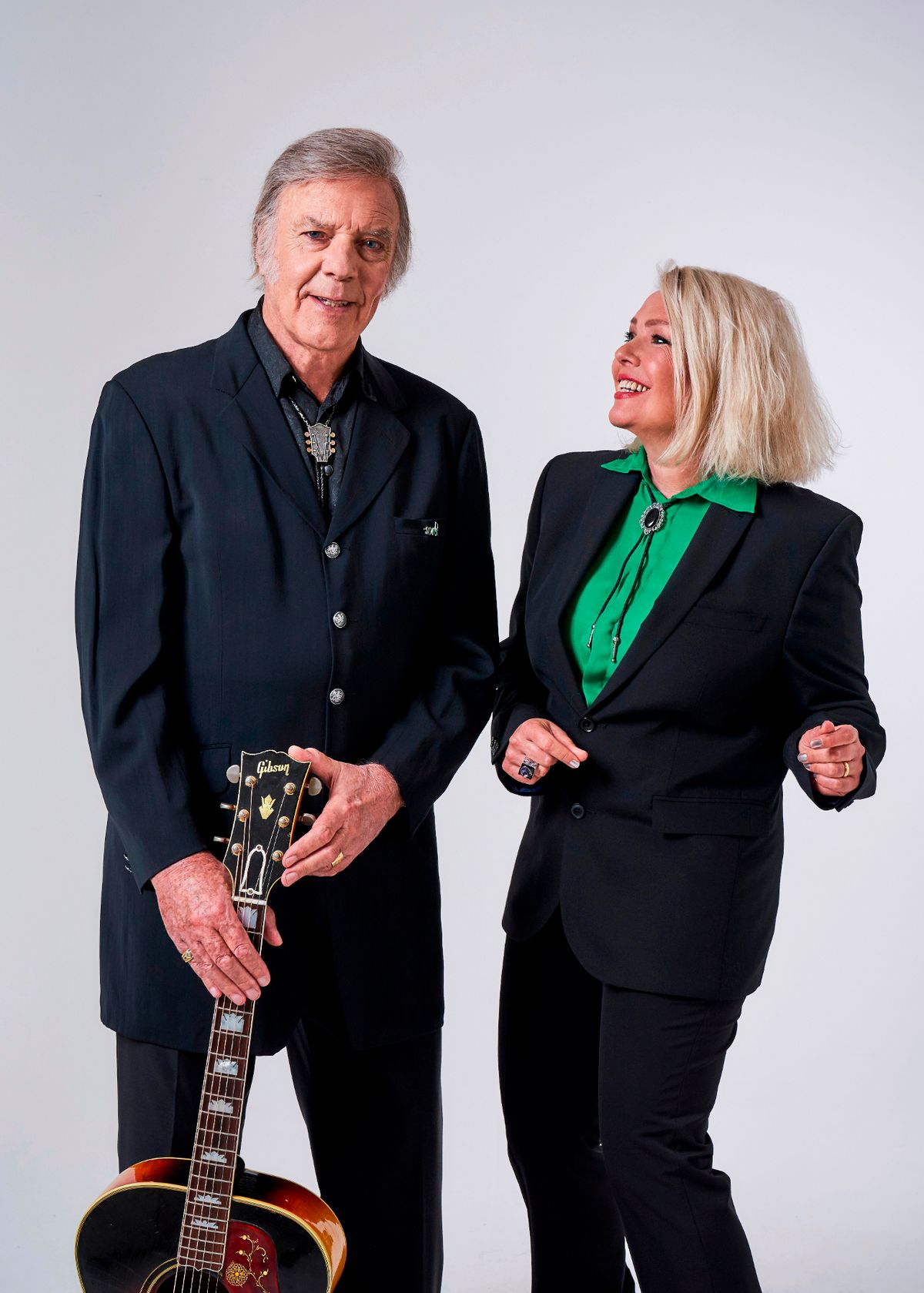 kim wilde looking up and smiling at her dad marty holding a guitar