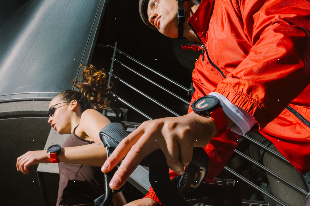 Two people on bikes wearing the Nothing CMF Watch 3 Pro