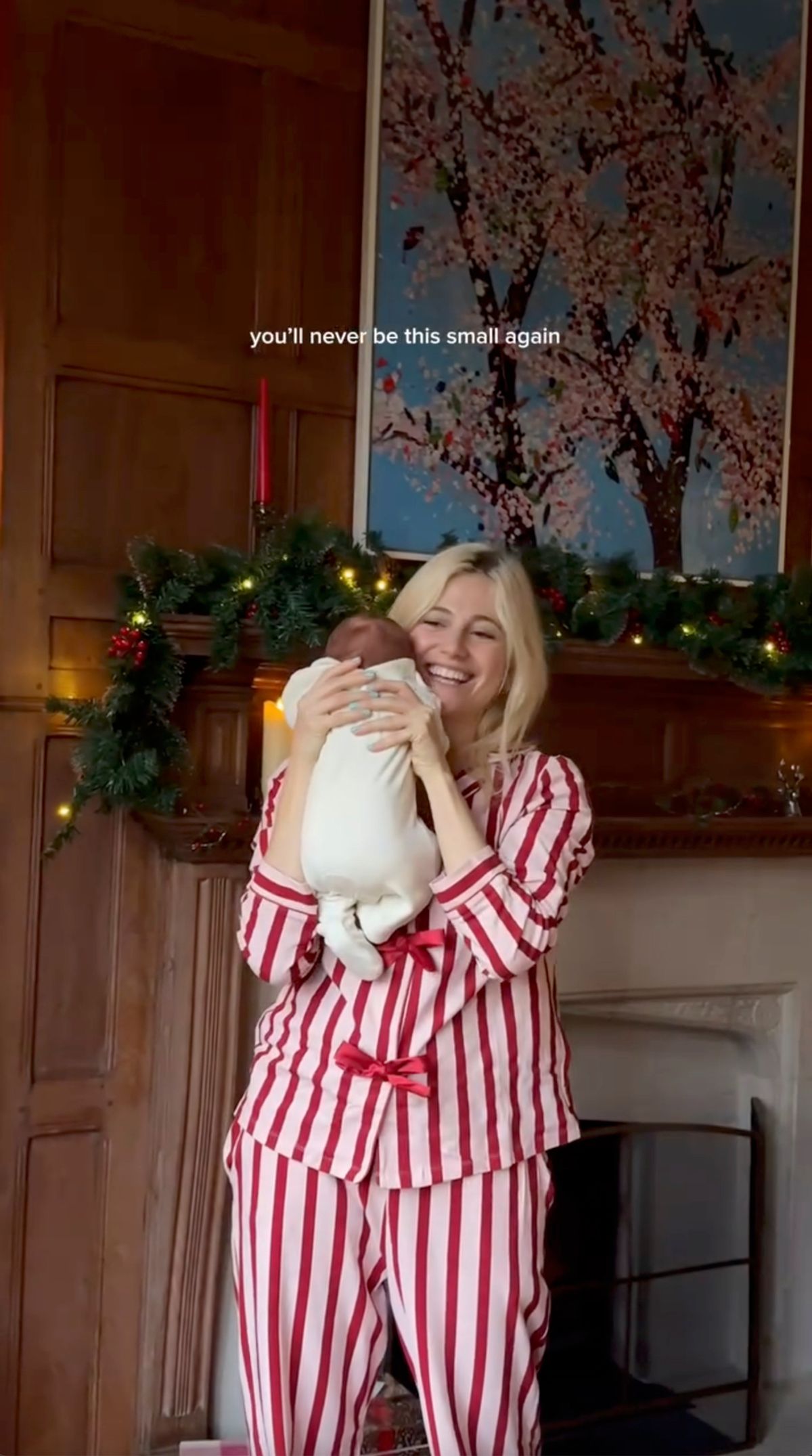 pixie lott in red and white striped pjs holding newborn