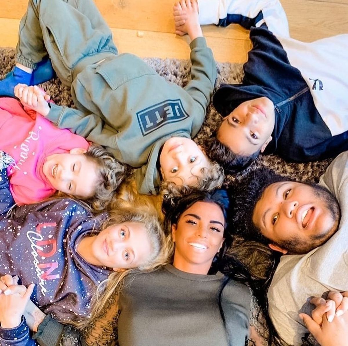 Katie Price lying on the floor with her five children