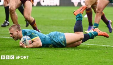 Hull KR stand-off Mikey Lewis, with the ball under his left arm, sliding over the line for a try