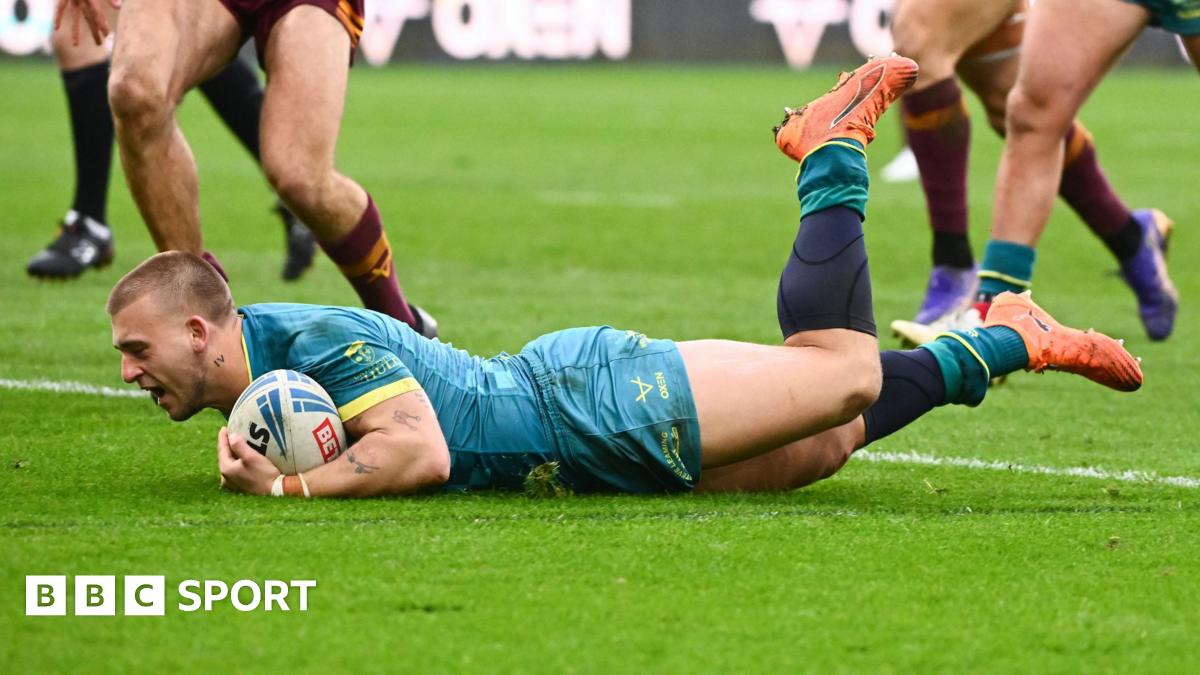 Hull KR stand-off Mikey Lewis, with the ball under his left arm, sliding over the line for a try