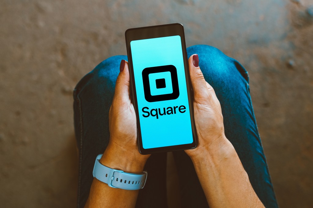 Illustration of a person holding a smartphone displaying the Square logo.
