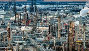 refinery at dusk with industrial buildings and oil and gas storage