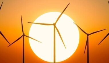 A wind farm in front of a sunstet