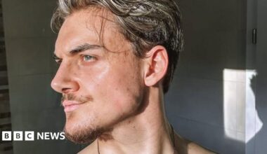 Marvin, a young man looking to the side with a defined jaw, wavy hair and some facial hair