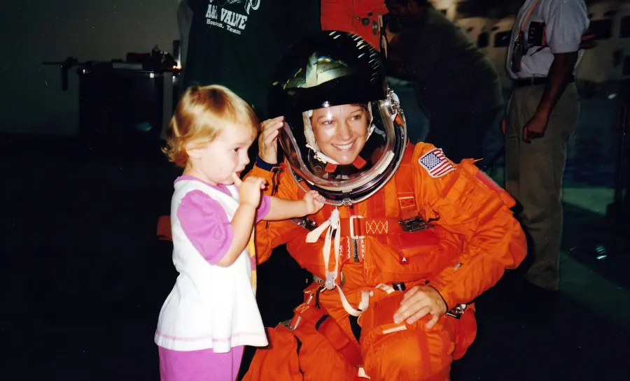 Eileen in space suit with daughter Bridget, age 3, in 1998.