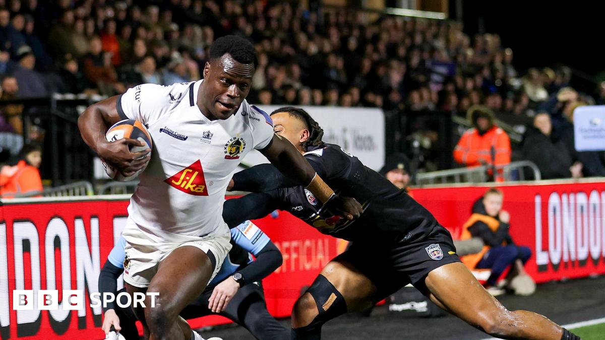 Exeter winger Paul Brown-Bampoe (left) with the ball in his right hand goes through an attempted tackle from Elliott Obatoyinbo