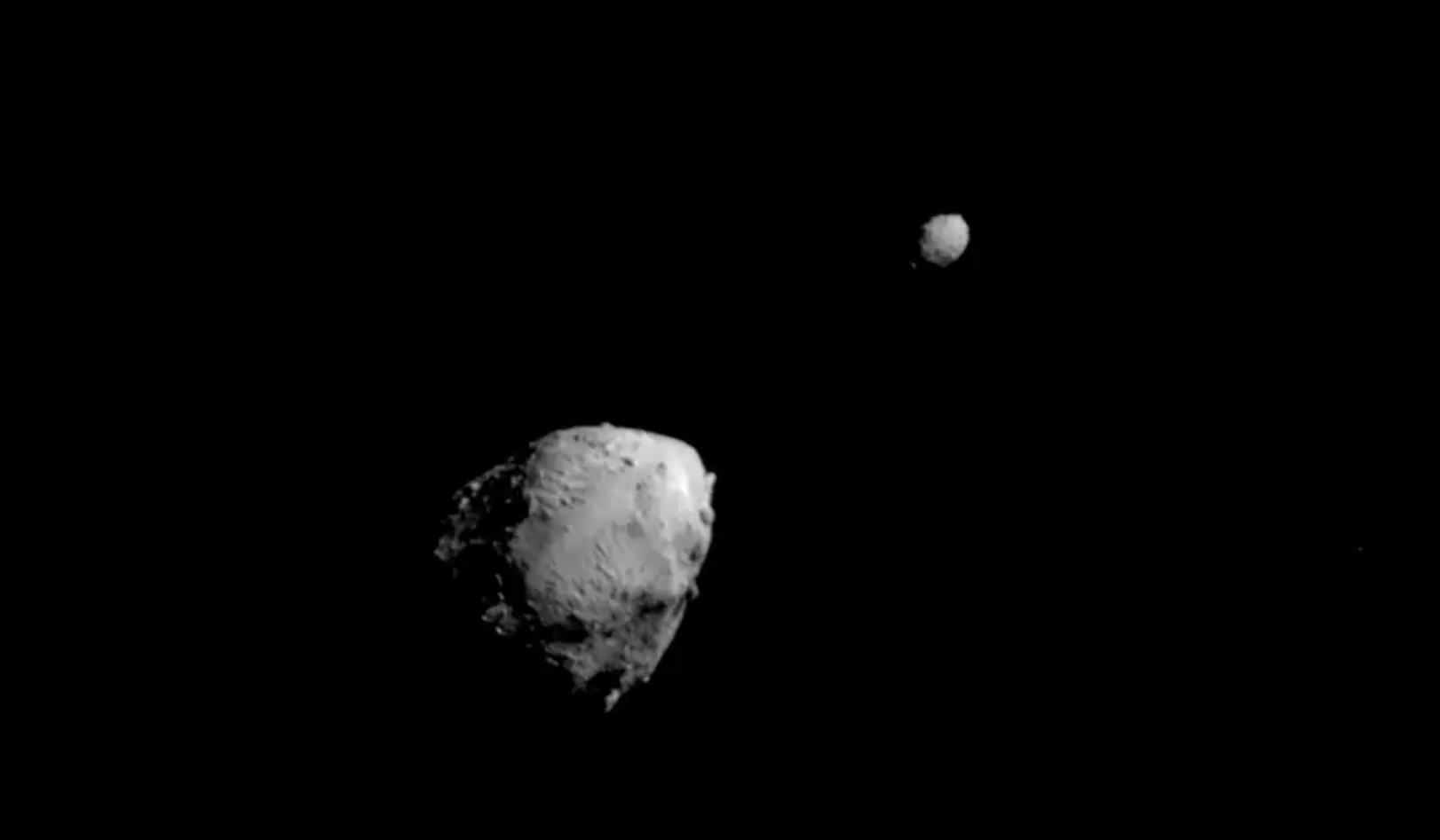 This image of asteroids Didymos, left, and Dimorphos was captured by NASA’s DART mission a few seconds before the spacecraft smashed into Dimorphos on Sept. 26th, 2022. Credit: NASA/Johns Hopkins APL