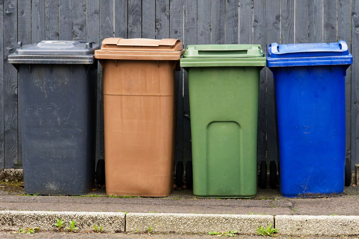 Wheelie bins in row segregated for recycling rubbish UK