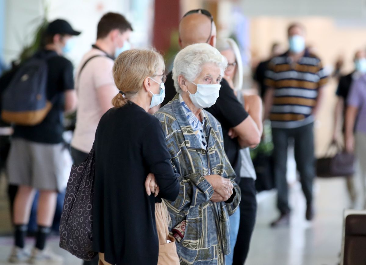 Passengers wait for a Qantas flight to Canberra at Adelaide Airport on November 18, 2020 in Adelaide, Australia