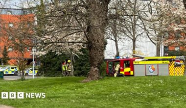 Emergency service vehicles outside a building.