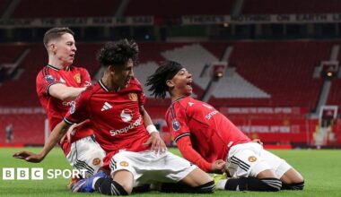 JJ Gabriel (centre) celebrates Junior Brown's (right) match winner with Jay McEvoy for Manchester United in the FA Youth Cup at Old Trafford