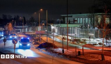 Police vehicles are parked outside the US embassy in Oslo