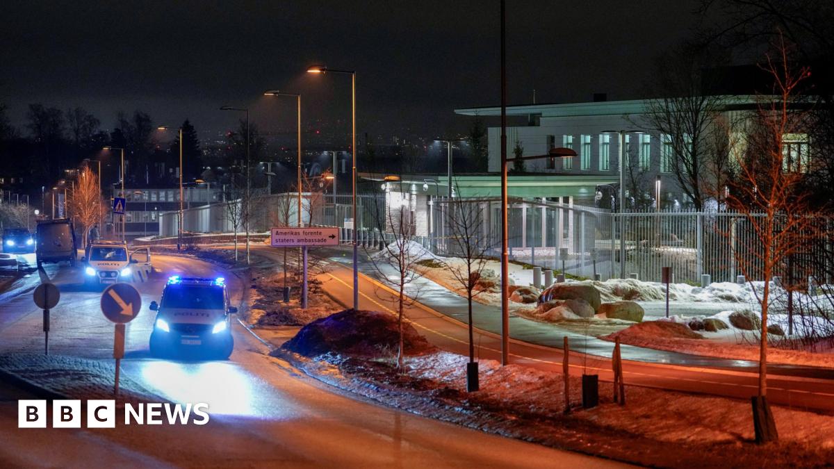 Police vehicles are parked outside the US embassy in Oslo