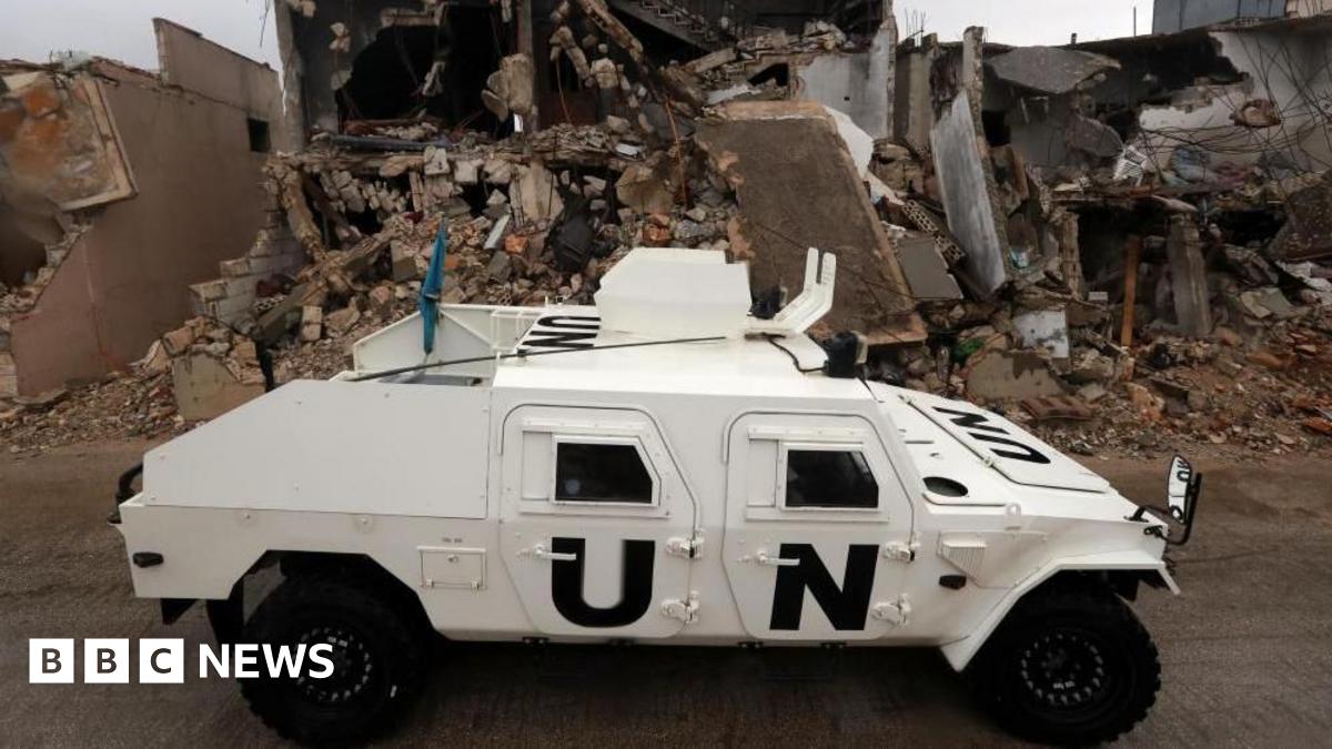 An armoured vehicle of the United Nations Interim Force in Lebanon (UNIFIL) drives next to destroyed buildings in Meiss al-Jabal, Marjayoun district, southern Lebanon, 08 December 2025.