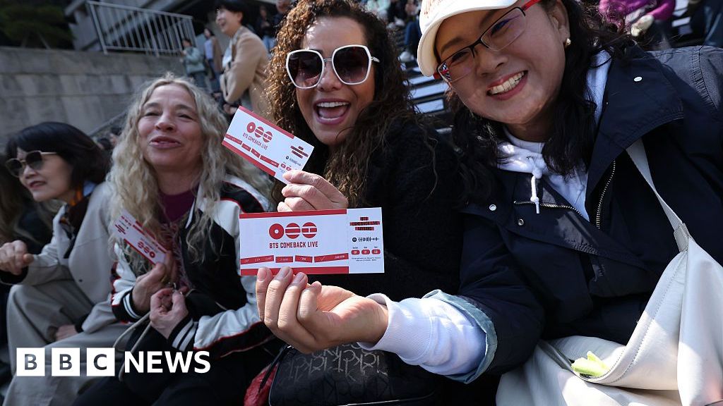 BTS fans in Seoul holding their tickets