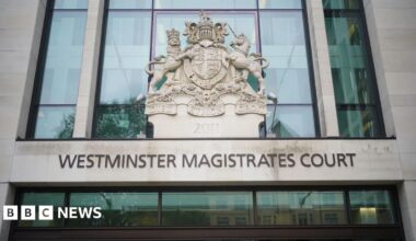 A general view of the entrance to Westminster Magistrates Court. The name of the court is written on the front of the building above an entrance. The HM Courts and Tribunal Service emblem rests above the court name.