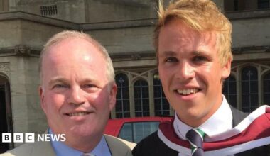 A head and shoulders image of Nick Apperley and his son Harry. They are both smiling and looking into the camera. Nick has a cream coloured jacket over a light blue shirt. Harry has a dark coloured jacket over a white shirt and a navy and green tie.