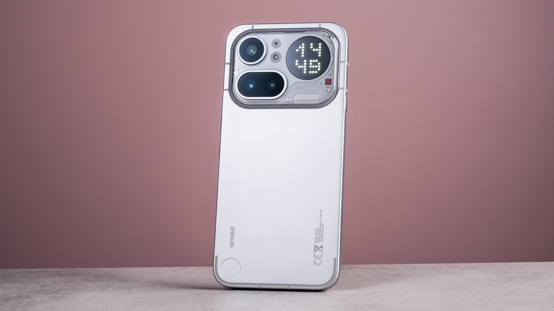 The Nothing Phone (4a) Pro's back showing its aluminum unibody, camera module and Glyph Matrix, which features a digital clock reading '14:49'.