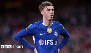 Cole Palmer standing with his hands on his hips during the defeat by Arsenal