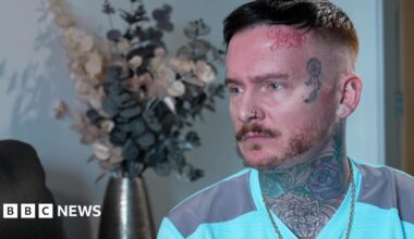 Andrew Dearden, wearing a green T-shirt with a full neck tattoo and an animal tattoo on his temple, speaks to the BBC