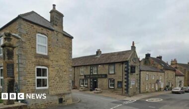 A view of the North Yorkshire village of Kirkby Malzeard showing a pub and various stone buildings
