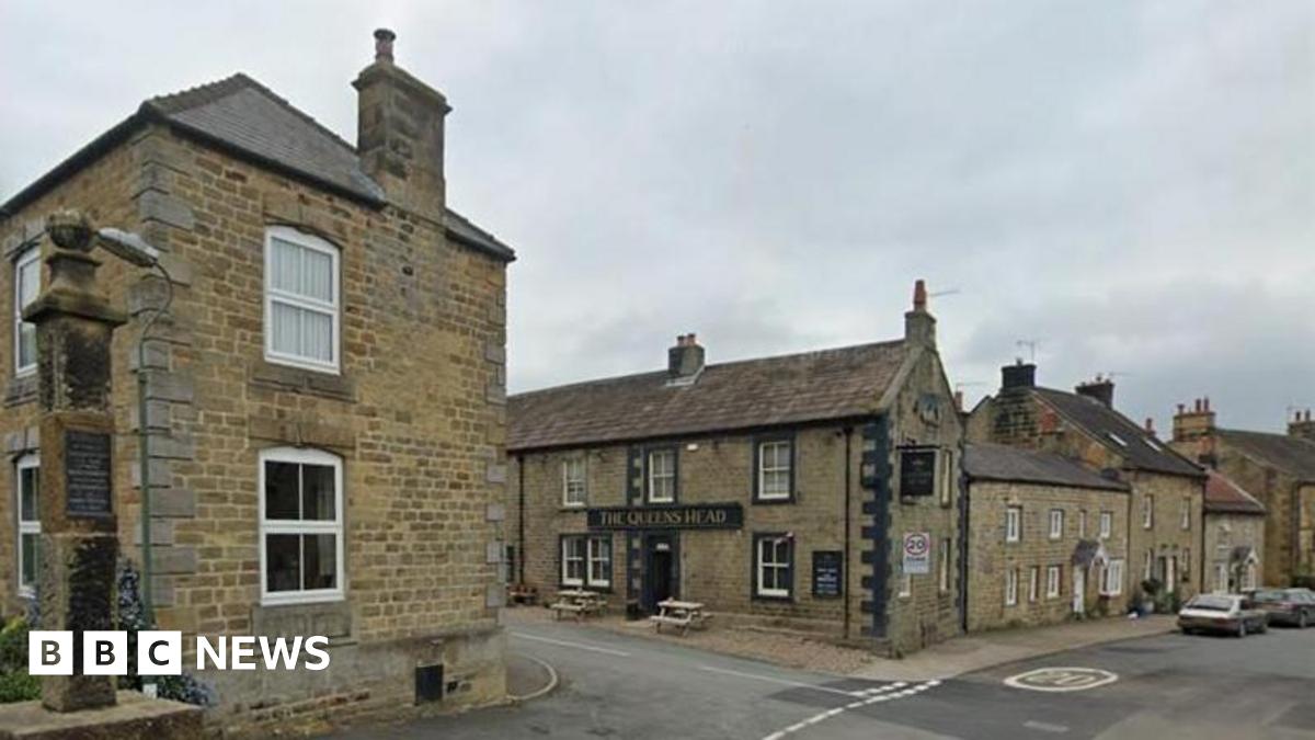 A view of the North Yorkshire village of Kirkby Malzeard showing a pub and various stone buildings