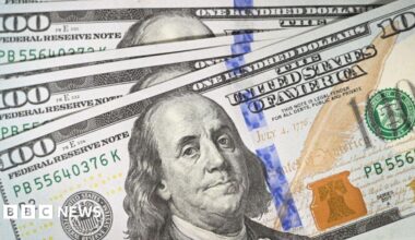 US President Donald Trump wears a navy suit and blue tie as he speaks to reporters before boarding Air Force One.