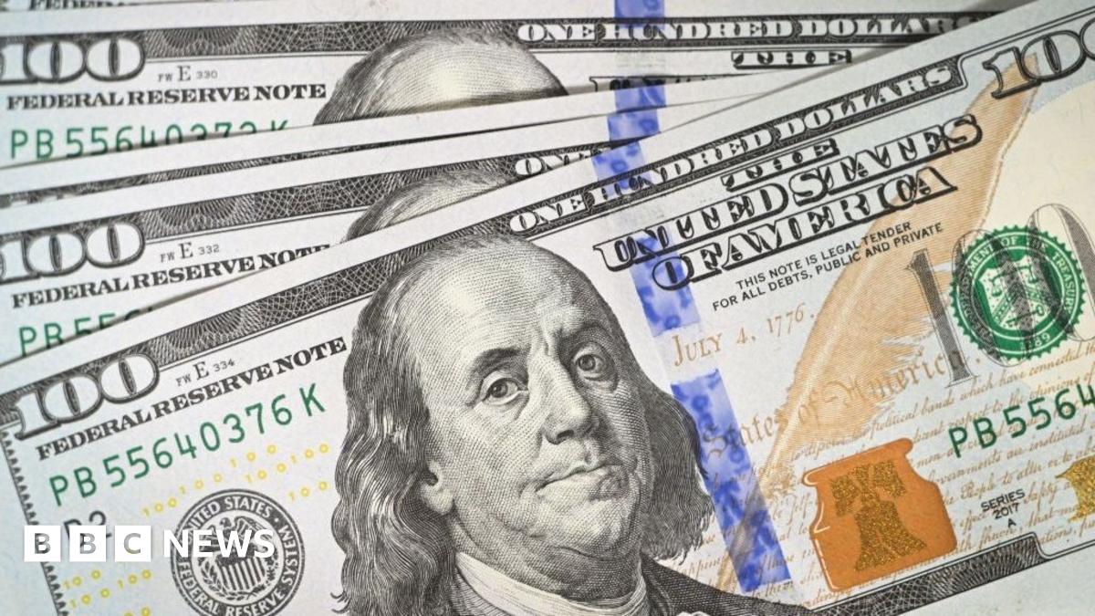 US President Donald Trump wears a navy suit and blue tie as he speaks to reporters before boarding Air Force One.