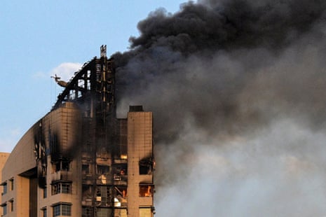 Smoke rises from a high-rise building following a drone attack in Kuwait City.