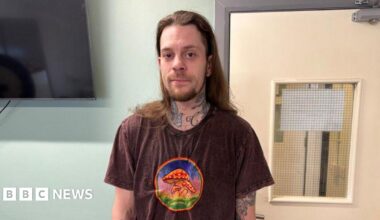 Curtis DuRose, a man with long brown hair, a beard and a brown t-shirt with red toadstools on it.