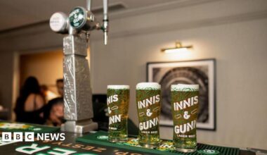 Three pints of Innis and Gunn on a bar with two Innis and Gunn taps next to it.
