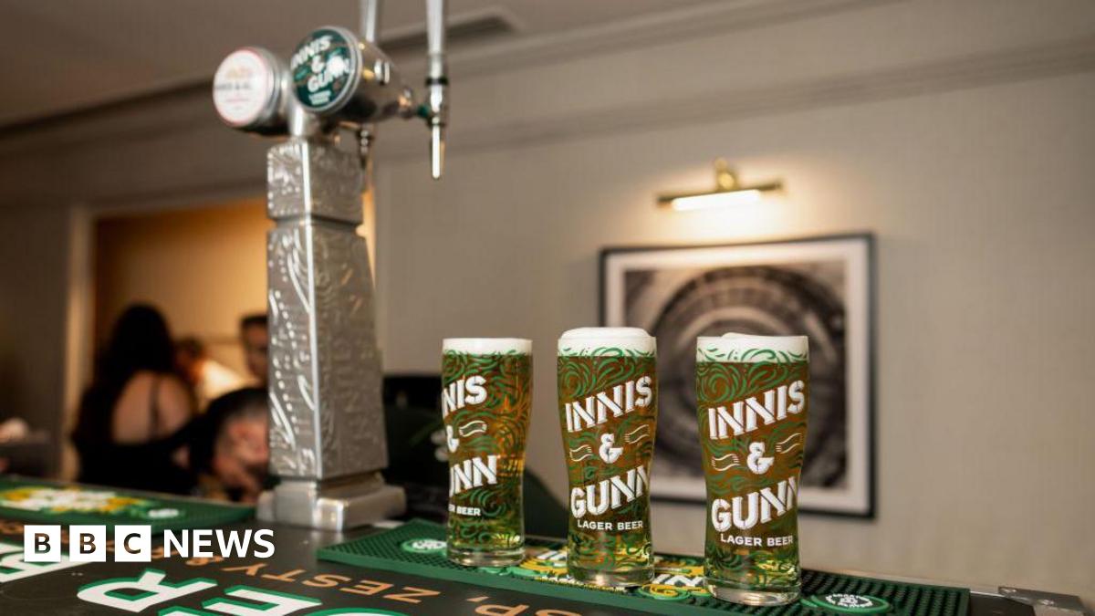 Three pints of Innis and Gunn on a bar with two Innis and Gunn taps next to it.