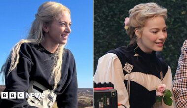 Jacob Elordi in a black suit as Heathcliff and Margot Robbie as Cathy in a white and red PVC dress