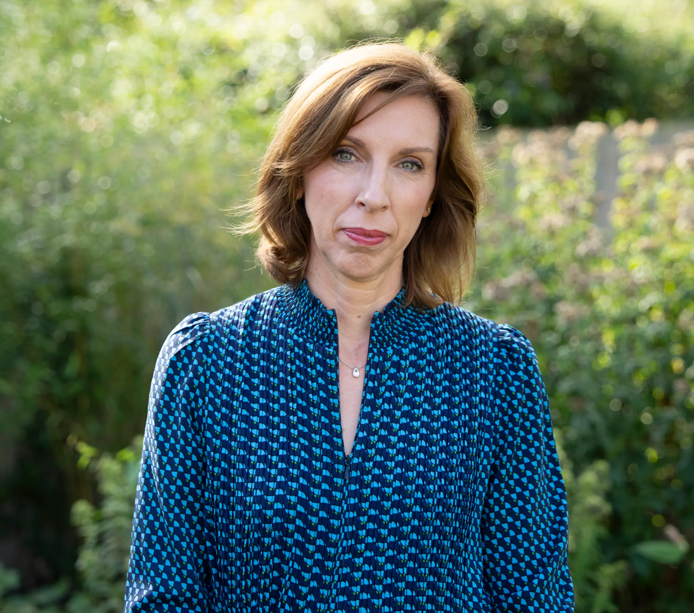 Dr. Louise Newson, a specialist in menopause and HRT treatment, standing in her garden.