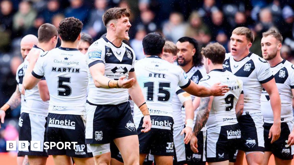 Hull FC players, in their white shorts and black shorts, celebrate a try against Catalans Dragons, with Davy Litten in the foreground urging the crowd to increase their support.