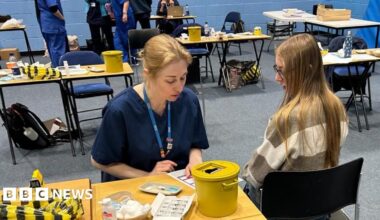 A student about to receive the Meningitis B vaccine at the University of Kent sports hall