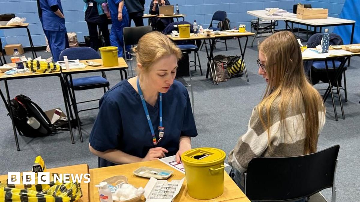 A student about to receive the Meningitis B vaccine at the University of Kent sports hall